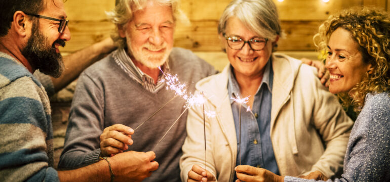 group of two seniors and two adults together having fun with spa