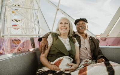 Cheerful senior couple enjoying a Ferris wheel by the Santa Monica pier